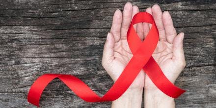 HIV ribbon in someone's hands