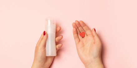 Hands holding lube and a heart shape